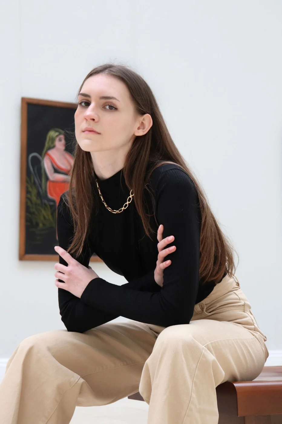 Black top and beige trousers in an art gallery.