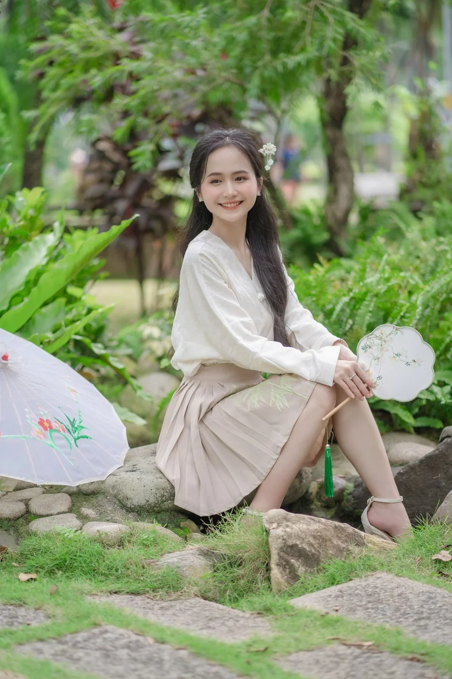White blouse and beige pleated skirt outdoors.