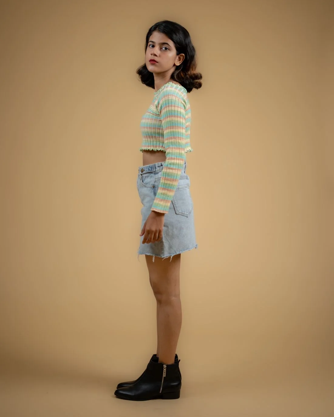 Striped jumper with a short denim skirt and ankle boots.