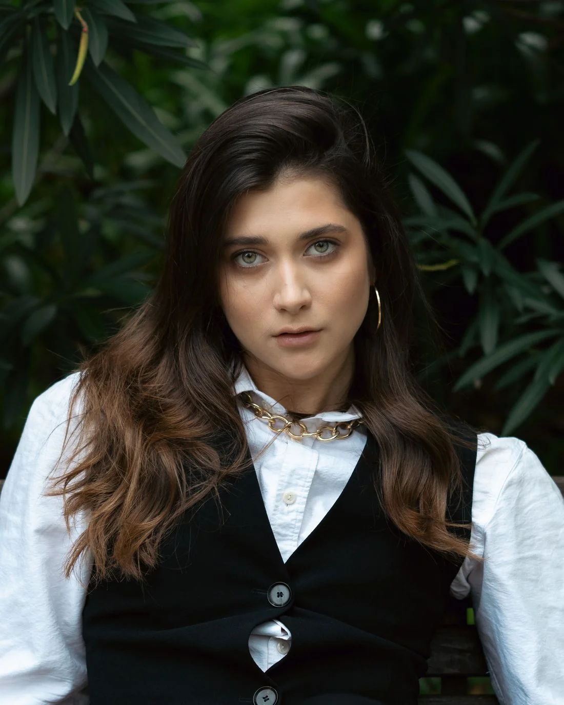 Black waistcoat over a white blouse.