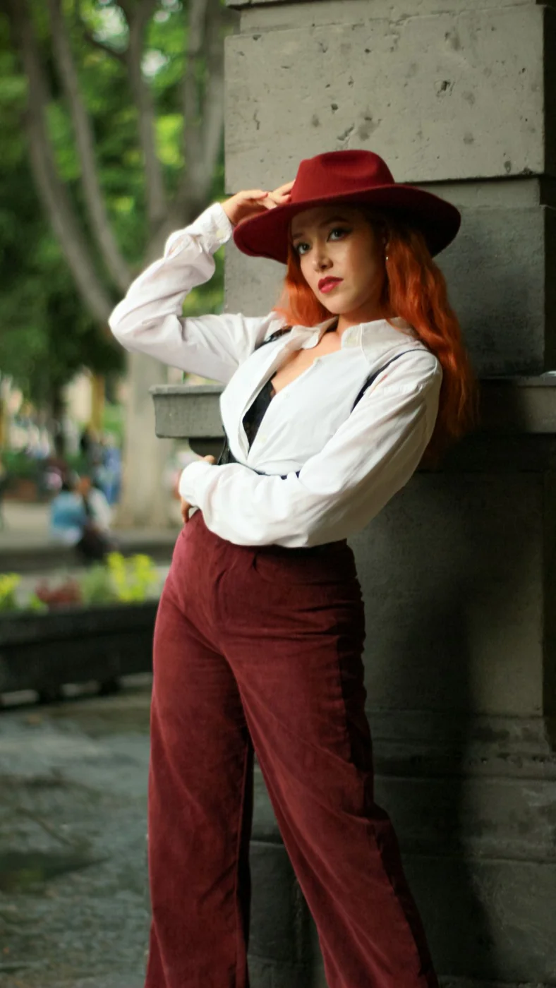 Dark red corduroy trousers with a white blouse and waistcoat.