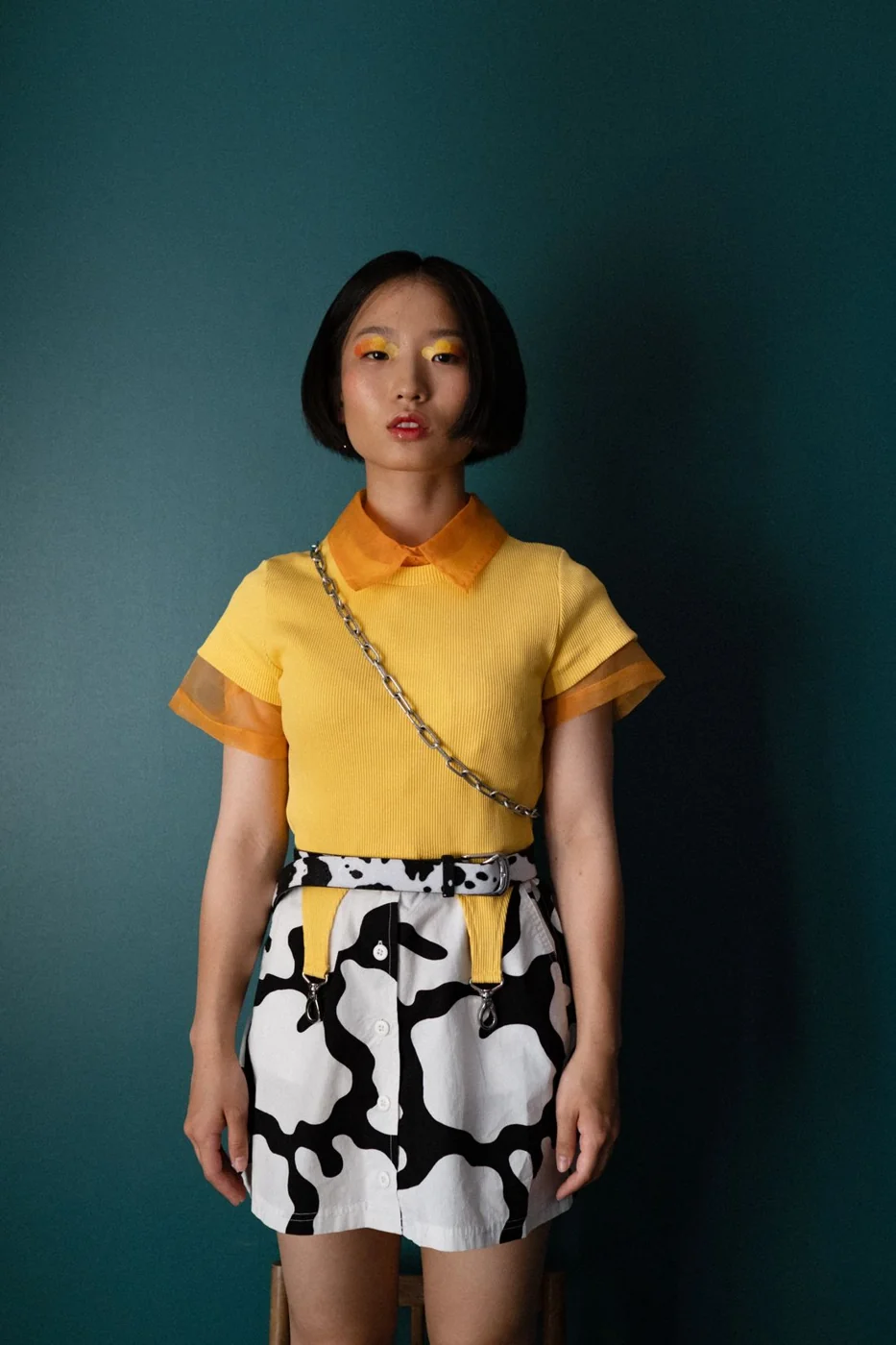 Yellow top with a black-and-white patterned skirt.