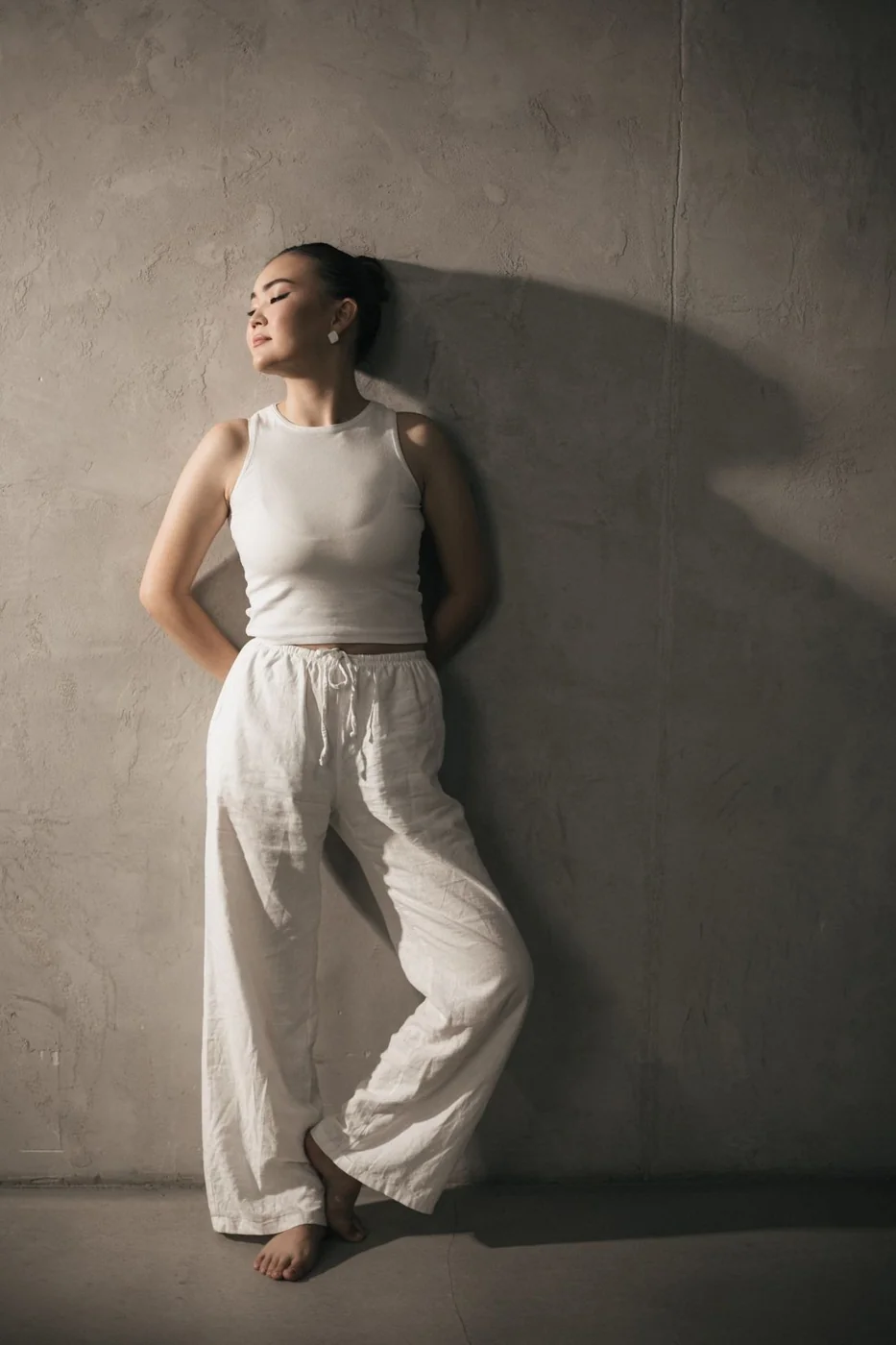 White linen trousers with a light sleeveless top.