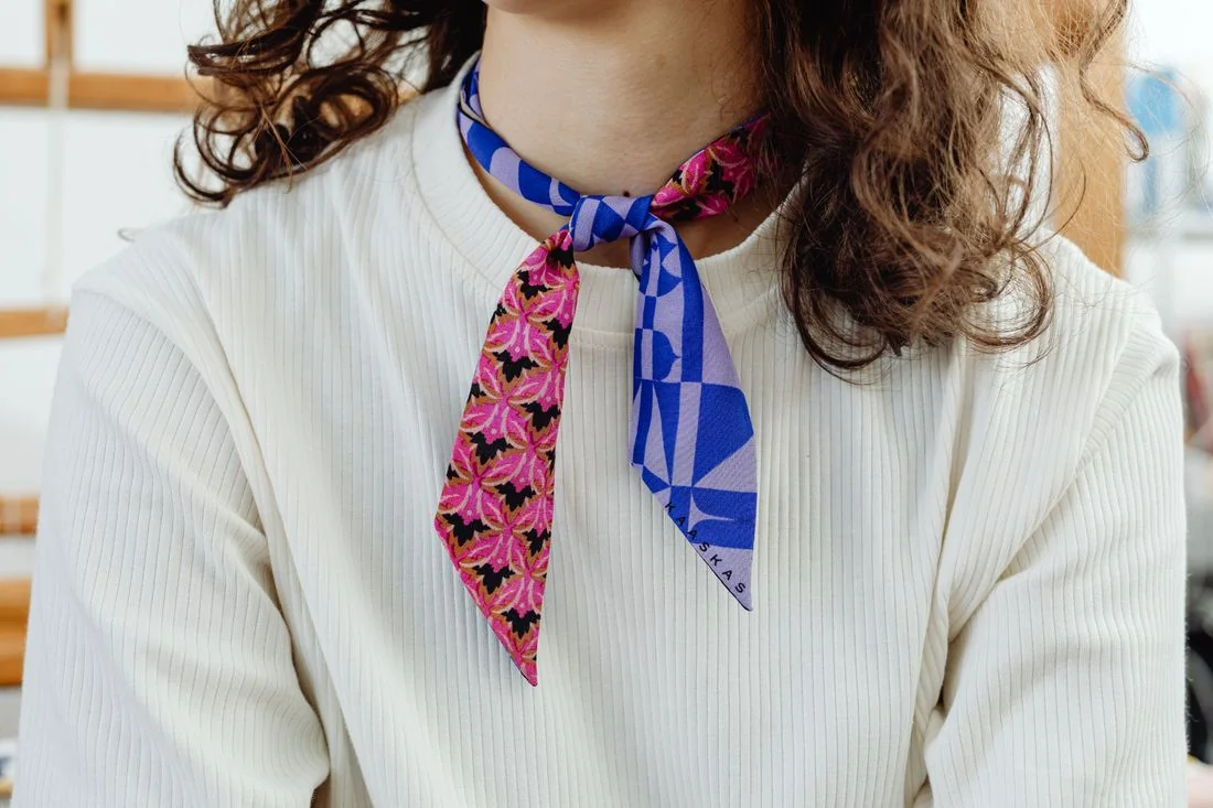 Colourfully patterned scarf with a plain white top.